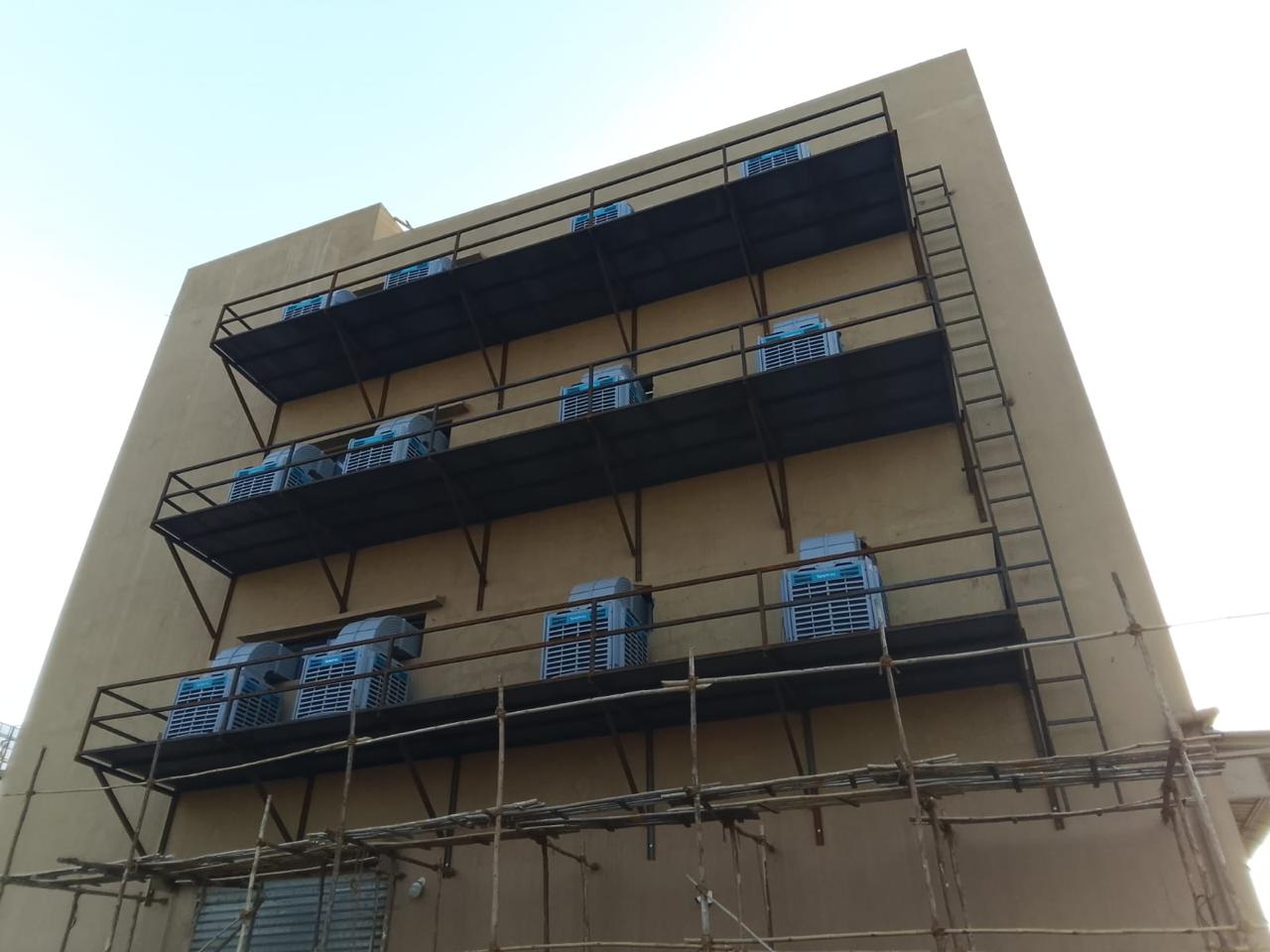 Industrial air coolers mounted on structural platforms across several floors.